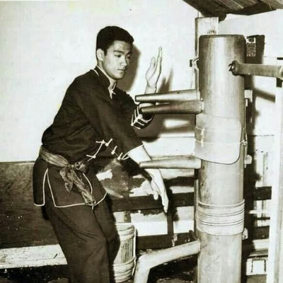 A young Bruce Lee training on the wooden dummy