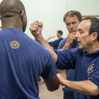 Sifu Rawcliffe teaching Wooden Dummy technique